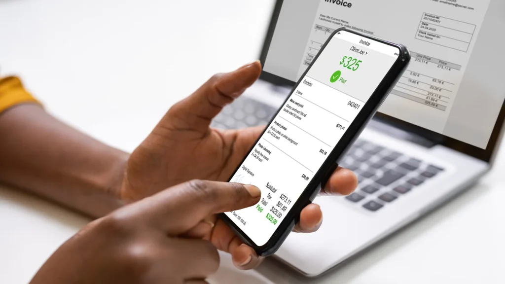 A mobile digital receipt and online invoice showcased on a laptop display
