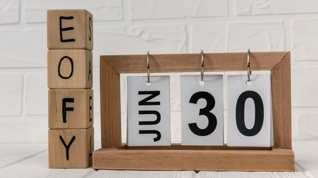 wooden block calendar with the letters eofy and June 30 depicted