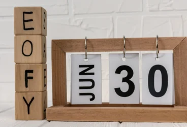 wooden block calendar with the letters eofy and June 30 depicted