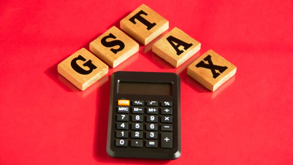 GST and Tax blocks with a Calculator on a red background