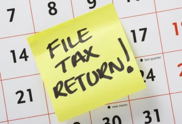 Calendar month of June with yellow sticky note reminder that says "file tax return!"